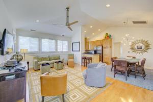 a living room with a table and a dining room at The Tides -- 19973 Sandy Bottom #302 in Rehoboth Beach
