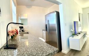 a kitchen with a refrigerator and a counter top at A1A Ocean Club in Flagler Beach