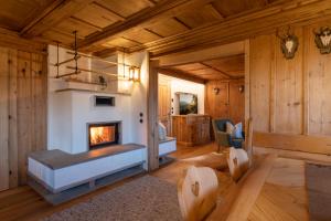 a living room with a fireplace in a log cabin at Golmerhaus in Schruns