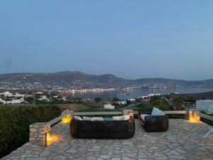 a patio with two couches and a view of the water at Villa Irene Blue in Krotiri