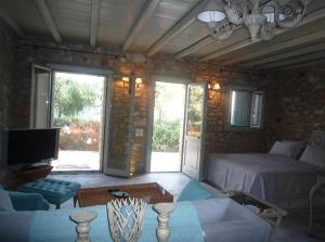 a living room with a bed and a couch at Villa Irene Blue in Krotiri