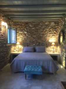 a bedroom with a large bed with a blue bench at Villa Irene Blue in Krotiri