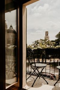 a table and chair on a balcony with a view at La Piu' Bella Verona in Verona