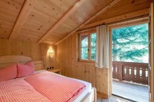 a bedroom with a bed and a window in a cabin at Golmerhaus in Tschagguns