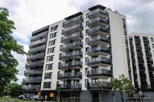 a tall white building with balconies on it at D Apartments Centrum Prowiantowa II in Białystok