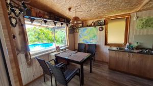 a kitchen and dining room with a table and a sink at Scent yard in Marijampolė