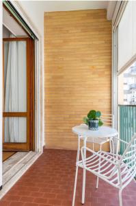 a white table and chairs on a balcony at Dimore Romano in Lecce