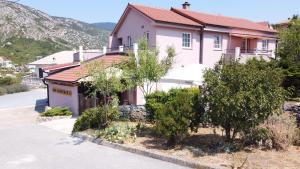 a house on the side of a road at BMB Apartments in Senj