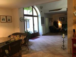 a living room with a large window and a table and chairs at Appartement près de DOLE in Menotey +12 photos