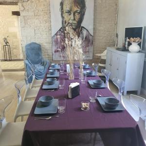 a table with a purple table cloth on top of it at Maison Laurenza 2 chambres d'hôtes in Saint-Jean-de-Liversay +15 photos