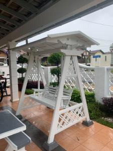 a white pergola sitting on top of a patio at Beit Azzahra in Kuantan