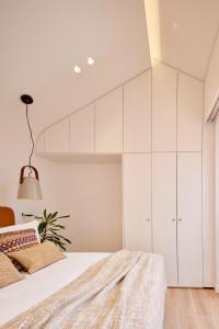 um quarto com armários brancos e uma cama em Bougainvillea 33 by My Cozy Home em Faro