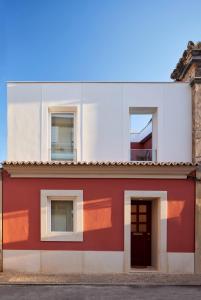 a red and white building with a door at Bougainvillea 33 by My Cozy Home in Faro