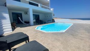 The swimming pool at or close to NV seafront villa Aegina 1