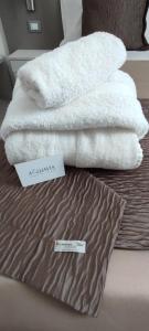 a pile of white towels sitting on top of a bed at B&B Aquavia in Porto Cesareo +46 photos
