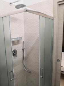 a shower with a glass door in a bathroom at B&B Aquavia in Porto Cesareo