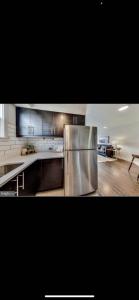 a large kitchen with a stainless steel refrigerator at Lovely 1-bedroom rental unit with free parking in Washington