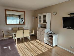 a living room with a table and a dining room at 2 pièces Plaza centre Valberg in Péone