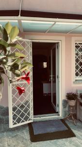 a pivot door to a room with a glass door at Casa vacanze La Villetta tra Cinque Terre e Versilia in Ameglia