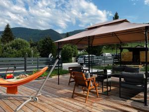 a hammock and an umbrella on a deck at Wilson Paradise Guest House in Thenneberg