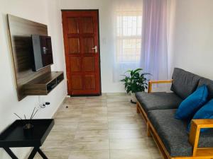 a living room with a couch and a flat screen tv at Molas Luxury Accomodation in Ga-Mothiba