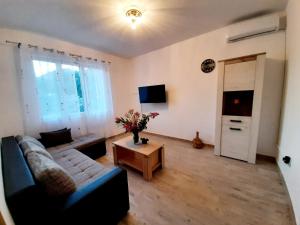 a living room with a blue couch and a table at Oaza in Komarna