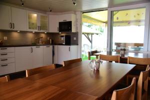 uma cozinha e sala de jantar com uma mesa de madeira em Hof-Tschannen em Lengwil