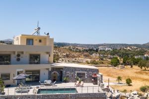 a villa with a swimming pool and a house at Des & Coo Luxury Villa with Private Pool in Faliraki