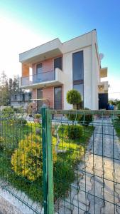 a fence in front of a house at Lovely Villa Ureki in Ureki