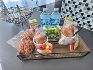 a tray with cookies and drinks on a counter at Le CONTI Proche Roissy - Astérix- Gare in Le Plessis-Belleville