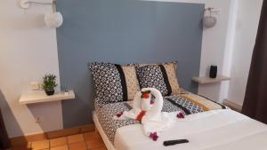 um quarto com dois cisnes sentados numa cama em -Résidence de la Baie- TARTANE- Apt "LE DODO BEACH SURF" em La Trinité