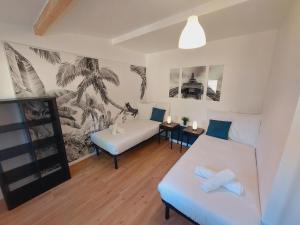 a living room with two beds and a couch at La Volcane - Maison au calme des Bois Royaux in Le Chesnay