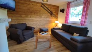 a living room with a couch and a table at Ferienhaus Rudolf in Achberg