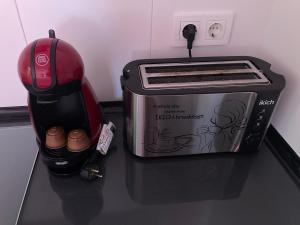 a toaster oven sitting on a counter next to a helmet at La casita de voto in Bádames