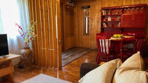 a living room with a table and a dining room at Cabana Paulina in Chişcău