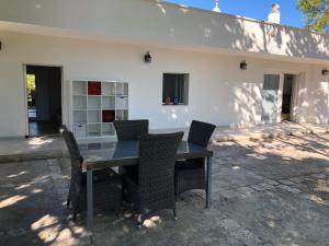 a table and chairs in front of a building at Villa Valentina in Locorotondo