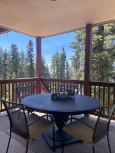 a blue table and chairs on a porch at YoBee! Park Reservation Included! Heart of Yosemite - Homey Studios and Breakfast in Yosemite West