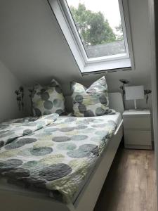 una cama en una habitación con ventana en Ferienwohnung Muh - Ostfriesland nähe Nordsee, en Rechtsupweg
