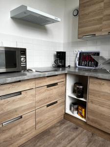 a kitchen with a counter top with a microwave at Chanoine Boursier in Dol-de-Bretagne