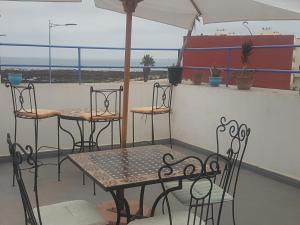 a patio with tables and chairs and a ship at Dar ziane 1 in El Jadida