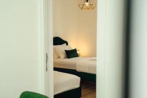 a small bedroom with two beds and a mirror at Baia di Cattaro in Kotor