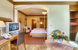 舍瑙阿姆克尼格塞的住宿－蓋瑞根霍夫酒店，一间带书桌的客厅和一间卧室