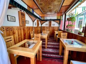 a dining room with wooden tables and chairs at Dar Belmamoun in Fez