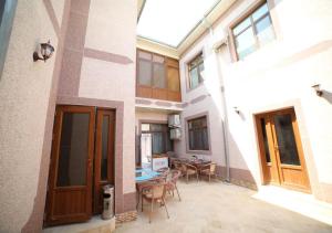 a courtyard of a house with a table and chairs at Murod Yusufiy Boutique Hotel in Bukhara