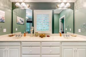 a bathroom with two sinks and a large mirror at 43 Trumpet Creeper in Kiawah Island +38 photos