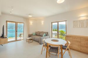 a living room with a table and a couch at Boka Apartment 6 in Herceg-Novi