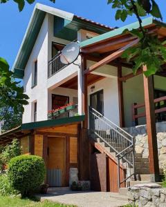 a house with a staircase leading up to it at Apartments Lux Labovic in Kolašin