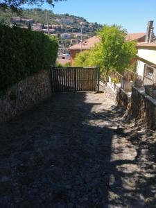 een oprit met een poort en een stenen muur bij Villino La Grotta in Porto Santo Stefano