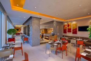 a dining room with tables and chairs in a restaurant at ibis Chennai Sipcot - An Accor Brand in Chennai