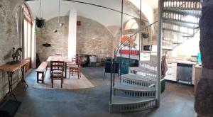 a kitchen with a staircase and a table and chairs at Historisches Rittergut Hexenburg Nähe Sächsische Schweiz, Dresden - mit Badeteich in Großharthau